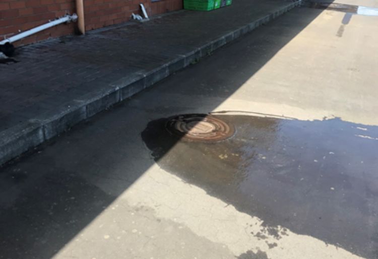 Manhole leaking on a driveway